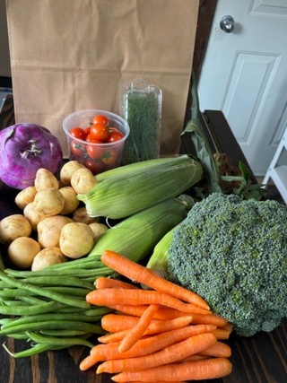Colourful selection of fresh vegetables from Maple Park Farm. Pictured is purple kohlrabi, cherry tomatoes, fresh dill, baby potatoes, green beans, carrots, broccoli and cucumber