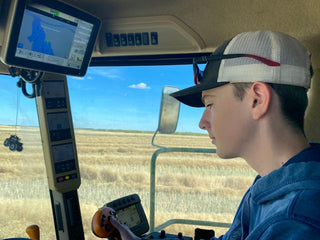 Ty operating the combine at harvest.  He is combining canola.